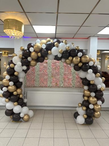 Ballonnenboog met zwarte witte en gouden ballonnen